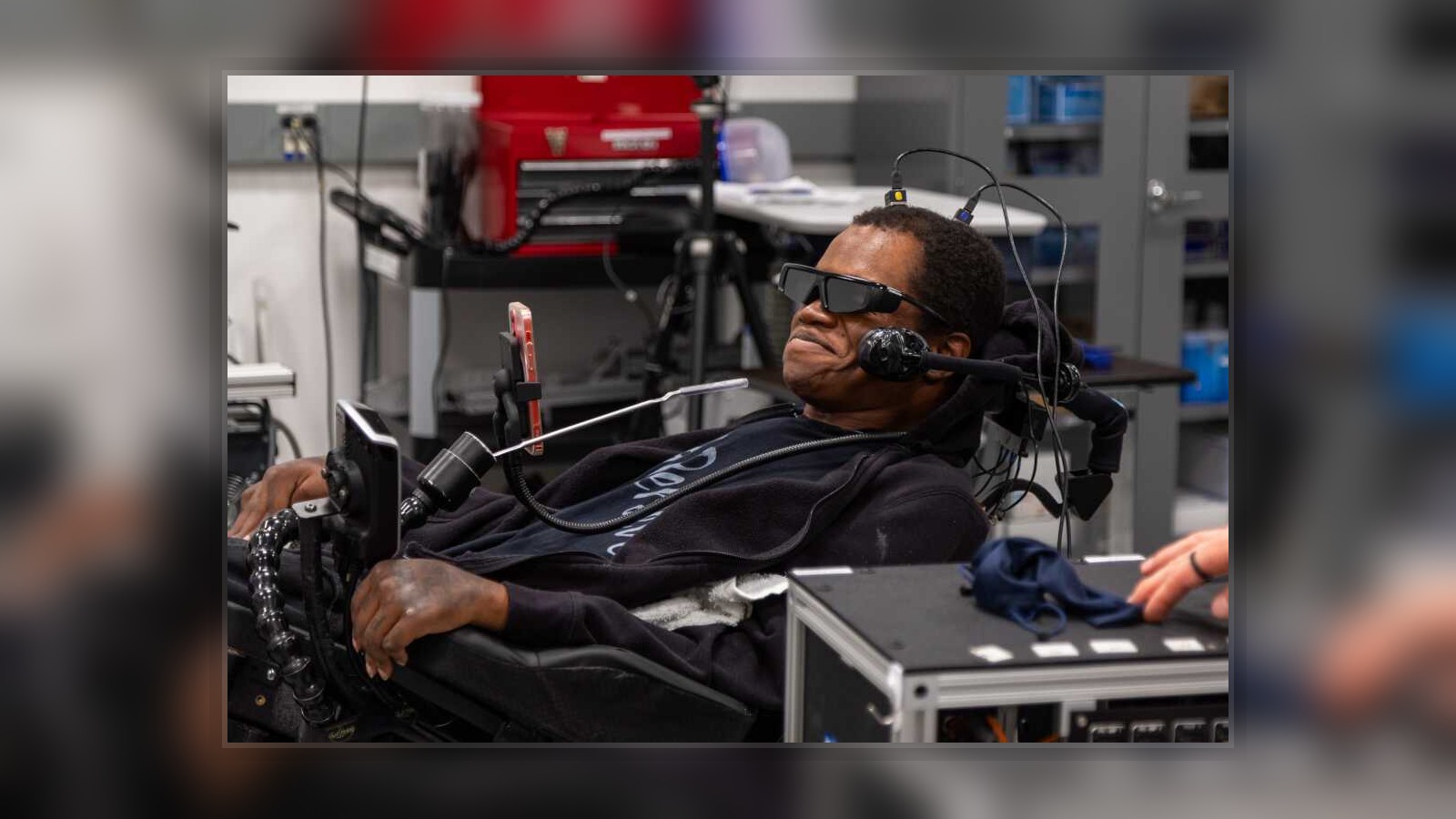 Real-world brain-computer interface assistive setup showing a user interacting with technology through a neural system